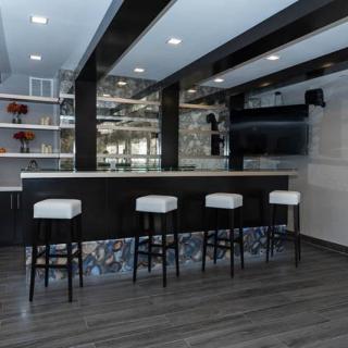 A modern bar interior with high stools and sleek design elements.