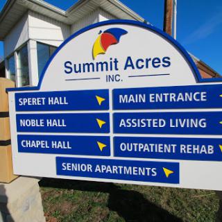 Directional sign for Summit Acres, indicating various facilities including assisted living and senior apartments.
