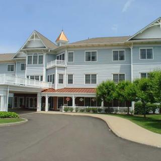 A large residential building with a landscaped entrance and driveway.