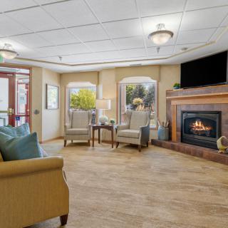 A cozy living room with a fireplace and comfortable seating area.