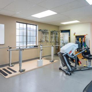 A well-equipped physical therapy gym showcasing various fitness equipment for rehabilitation and training.