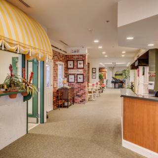 A warmly decorated lobby with a reception desk and seating area.