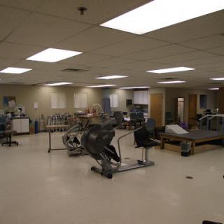 A spacious fitness and rehabilitation area equipped with various exercise machines.