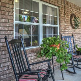A cozy porch with rocking chairs and a hanging plant.
