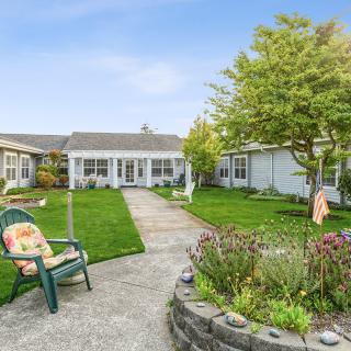 A serene courtyard with a landscaped garden and outdoor seating on a sunny day.