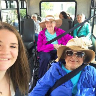A group of women enjoying a bus ride together.