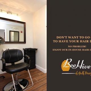 Cozy hair salon space with a chair and mirror, promoting home appointment services.