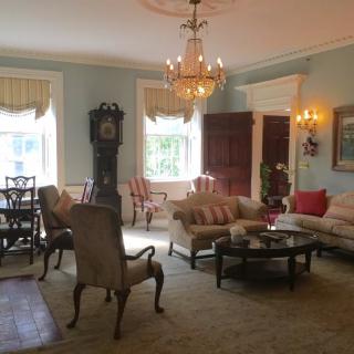 A classic living room with elegant furniture and a chandelier.
