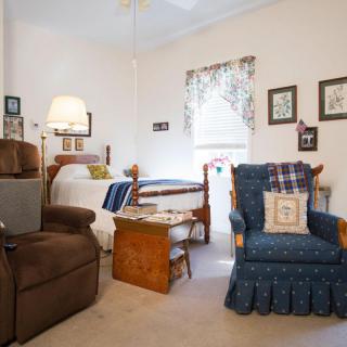 A cozy living room with comfortable chairs and homey decor.
