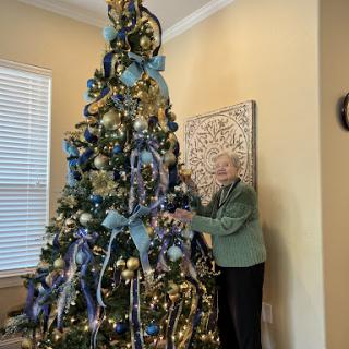 A beautifully decorated Christmas tree adorned with blue and gold decorations, perfect for the holiday season.