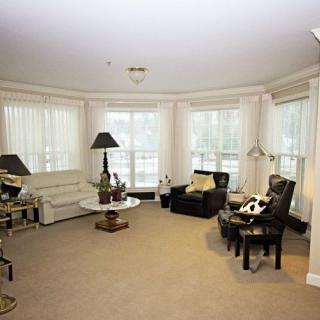 A cozy living room with comfortable seating and ample natural light.