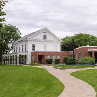 A charming blend of historic and modern architecture surrounded by lush green grass.