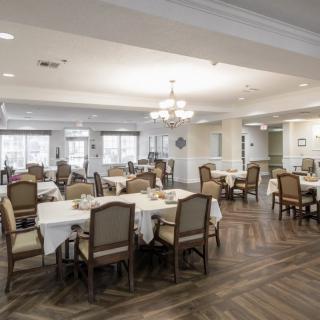 Spacious and elegantly decorated dining area with neatly arranged tables and chairs.