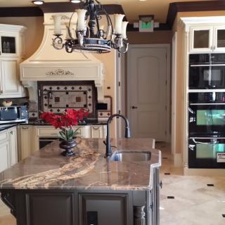 A luxurious kitchen with a marble island and modern appliances.