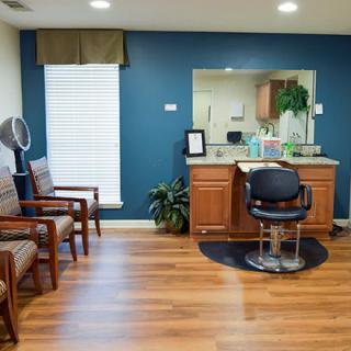 A well-organized hair salon with a styling chair, mirror, and seating area.