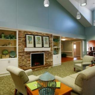 A cozy living room with a fireplace and comfortable seating.