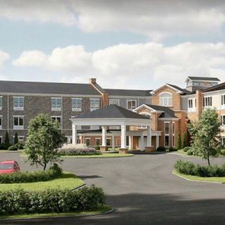 A residential building with landscaped surroundings and a main entrance.