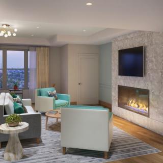 A modern living room featuring a fireplace, television, and a stylish seating area with a window view.