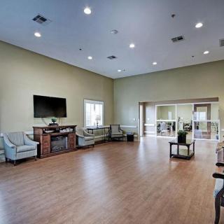 A spacious living room with a fireplace, TV, and comfortable seating.