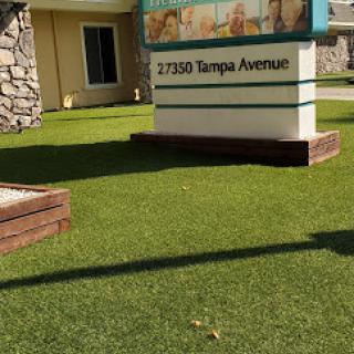 A sign displaying the address '37350 Tampa Avenue' in a well-maintained grassy area.