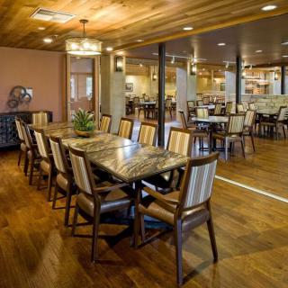 Elegant dining area with wooden flooring and modern decor.