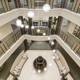 A modern atrium with bright lighting and elegant furnishings in a multi-story lobby.