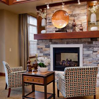 A beautifully designed living room featuring stylish furniture and a warm fireplace.