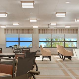 A bright and spacious interior seating area with tables and chairs beside large windows.
