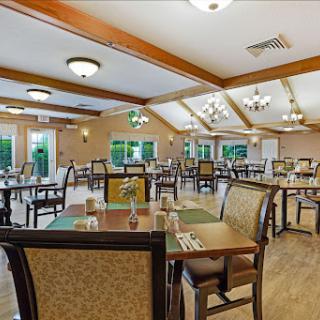 A spacious dining room set up for meals, featuring well-arranged tables and comfortable seating.
