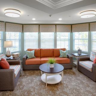 A cozy living room with comfortable seating and large windows.