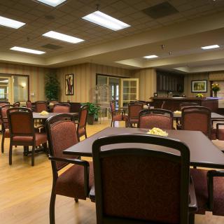 An empty dining area with neatly arranged tables and chairs.