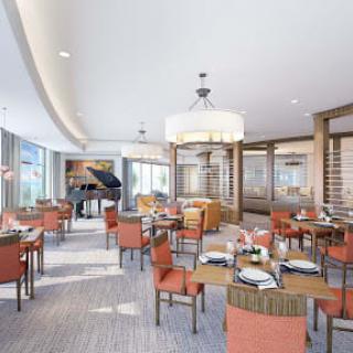 A well-lit, elegant dining area featuring multiple tables and comfortable seating.