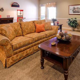 A cozy living room with a patterned sofa and wooden coffee table.