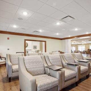 A modern waiting room with comfortable seating and bright lighting.