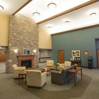 A modern lobby area featuring comfortable seating and a fireplace.