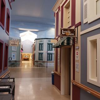 A vibrant interior corridor designed to resemble a quaint street scene.