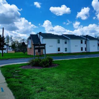 A sunny day showcasing a row of residential buildings against a backdrop of beautiful clouds.