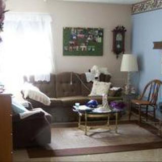 A cozy living room area with a sofa, coffee table, and decorative elements.