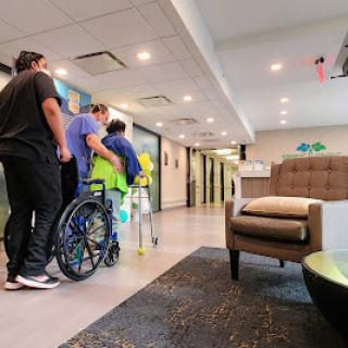 Caregivers assisting a patient in a healthcare facility.