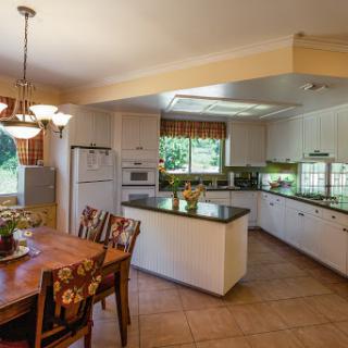 A spacious and well-lit kitchen featuring modern design elements and a cozy dining area.