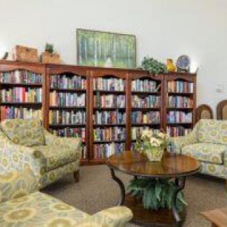 A cozy living room with bookshelves and comfortable seating.