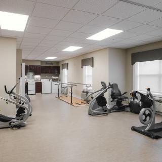 A well-equipped gym with various exercise machines and a modern interior.