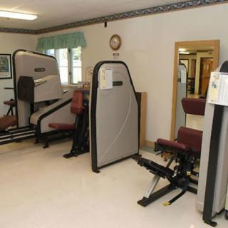 A small gym with various exercise machines for workouts.