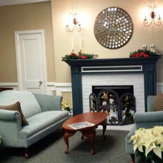 A cozy living room with a stylish fireplace and comfortable seating.