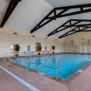 An inviting indoor swimming pool with vaulted ceilings and ample natural light.