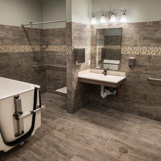 A modern, accessible bathroom with a walk-in tub and safety features.