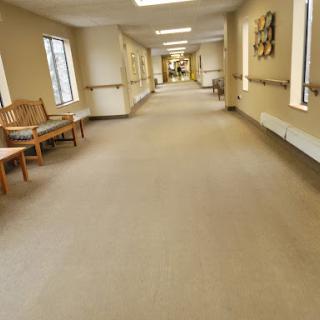 A well-lit hallway featuring benches and decorative elements along the walls.