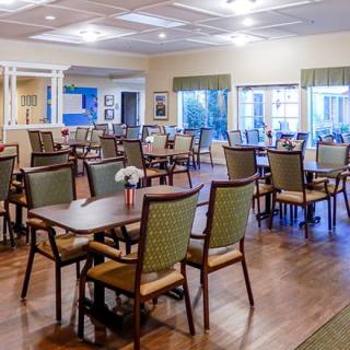 A spacious dining room with neatly arranged tables and chairs.