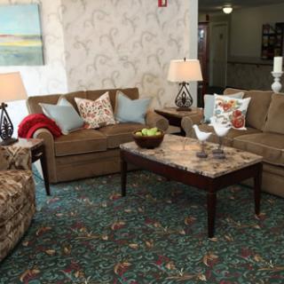 A cozy living room setup featuring comfortable seating and decorative accents.