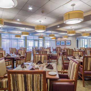 An elegant restaurant interior with neatly arranged tables and chairs.